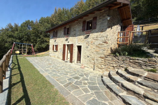 Stone house with a garden on a hillside in Menaggio