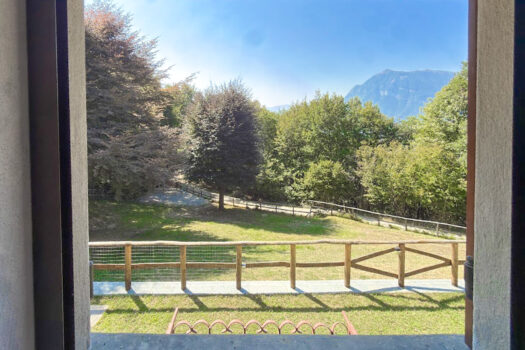 Stone house with a garden on a hillside in Menaggio