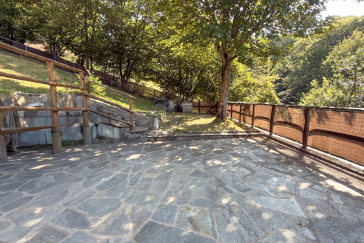 Stone house with a garden on a hillside in Menaggio