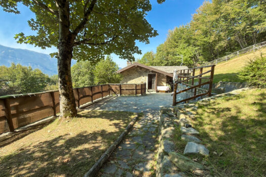 Stone house with a garden on a hillside in Menaggio