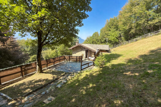 Stone house with a garden on a hillside in Menaggio