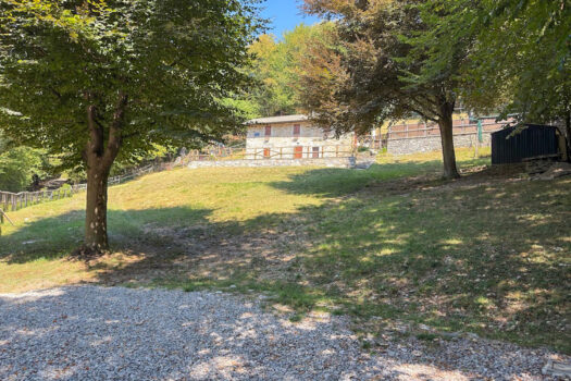 Stone house with a garden on a hillside in Menaggio