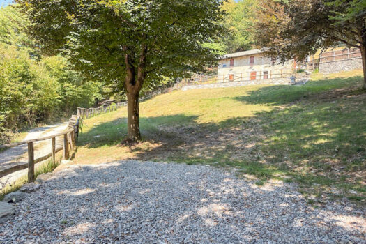 Stone house with a garden on a hillside in Menaggio