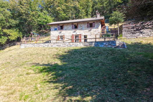 Stone house with a garden on a hillside in Menaggio
