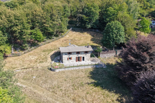 Stone house with a garden on a hillside in Menaggio