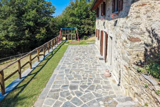 Stone house with a garden on a hillside in Menaggio