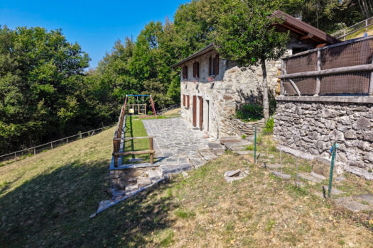 Stone house with a garden on a hillside in Menaggio