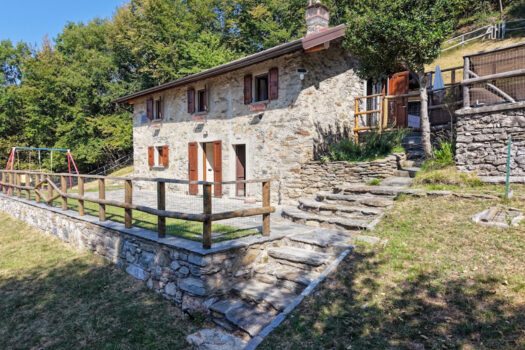 Stone house with a garden on a hillside in Menaggio