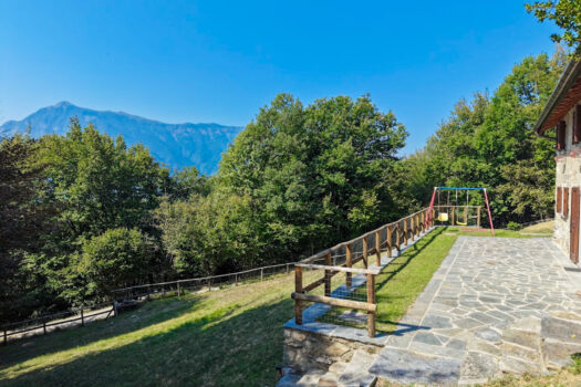 Stone house with a garden on a hillside in Menaggio