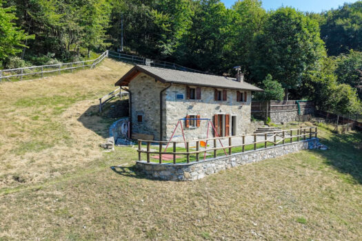 Stone house with a garden on a hillside in Menaggio