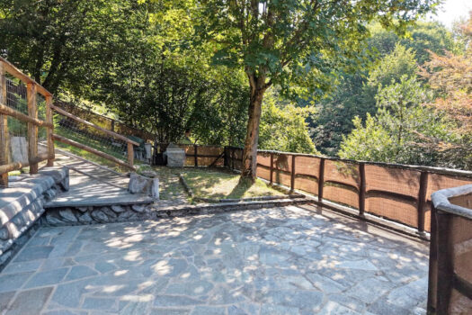 Stone house with a garden on a hillside in Menaggio