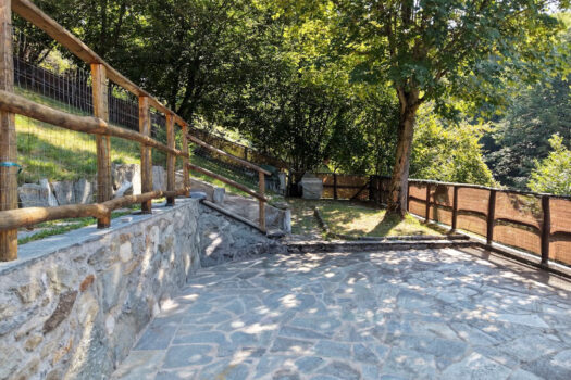 Stone house with a garden on a hillside in Menaggio