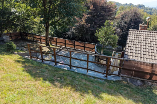 Stone house with a garden on a hillside in Menaggio