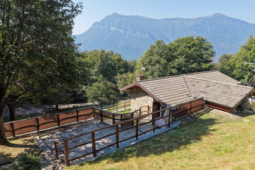 Stone house with a garden on a hillside in Menaggio
