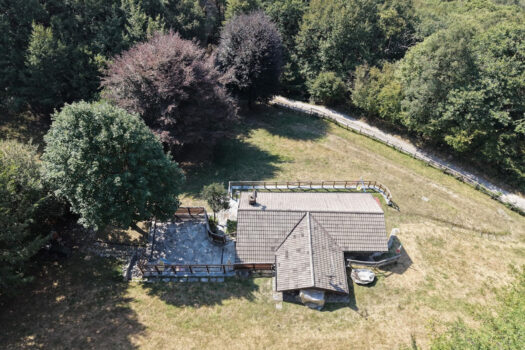 Stone house with a garden on a hillside in Menaggio
